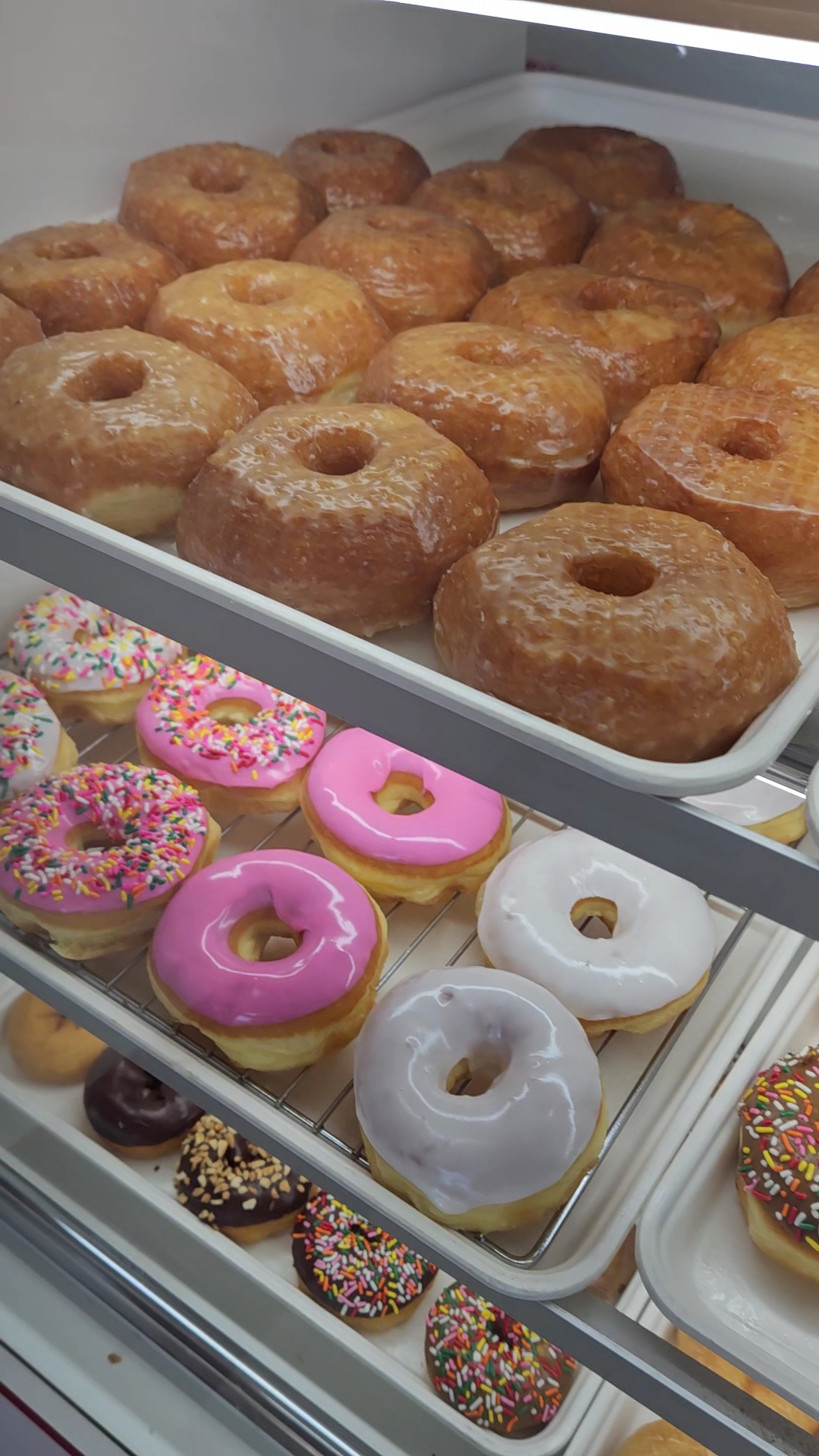 Pink-frosted donuts topped with sprinkles